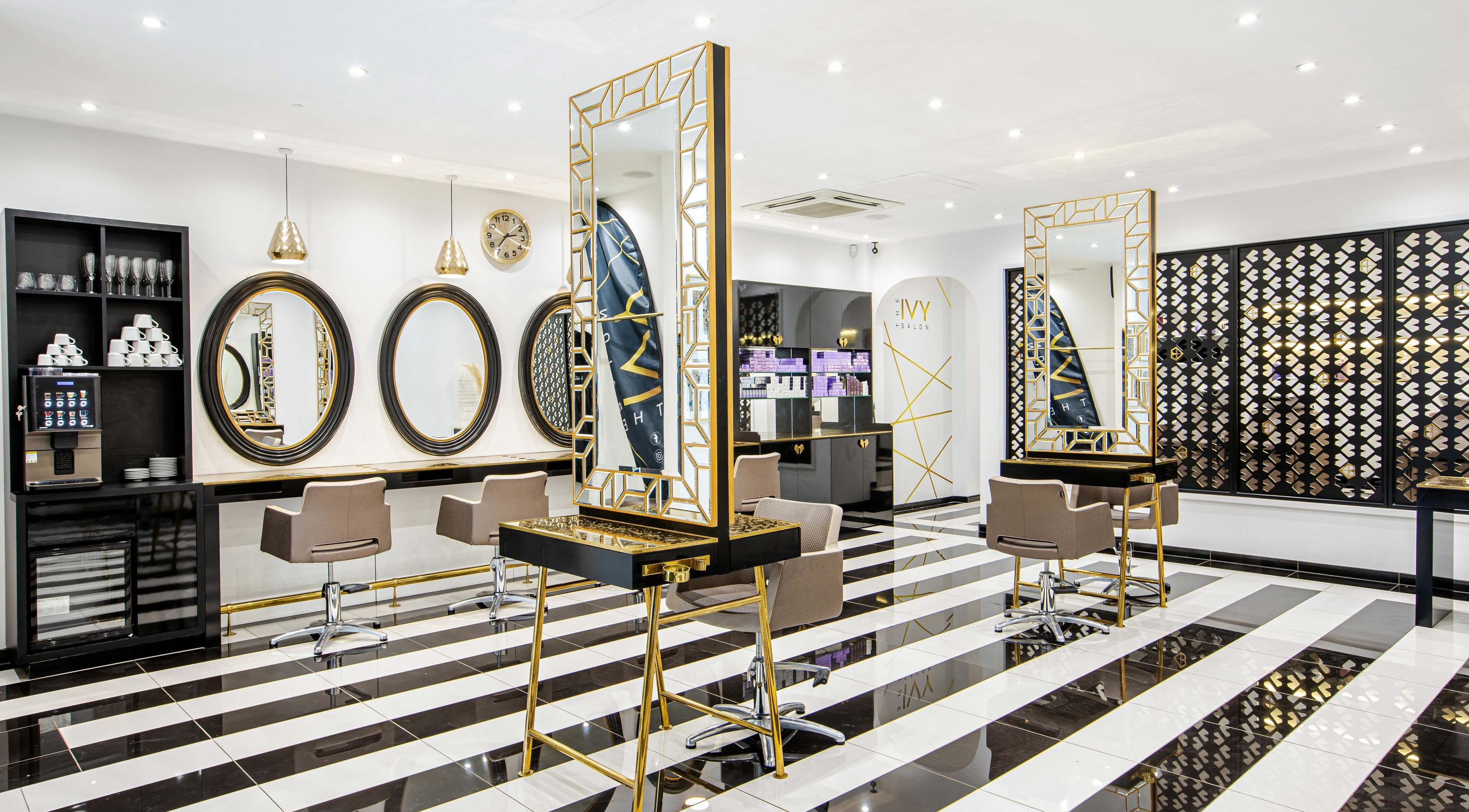 Modern interior at The Ivy Salon, Torquay, England, GB with sleek mirrors and stylish chairs.