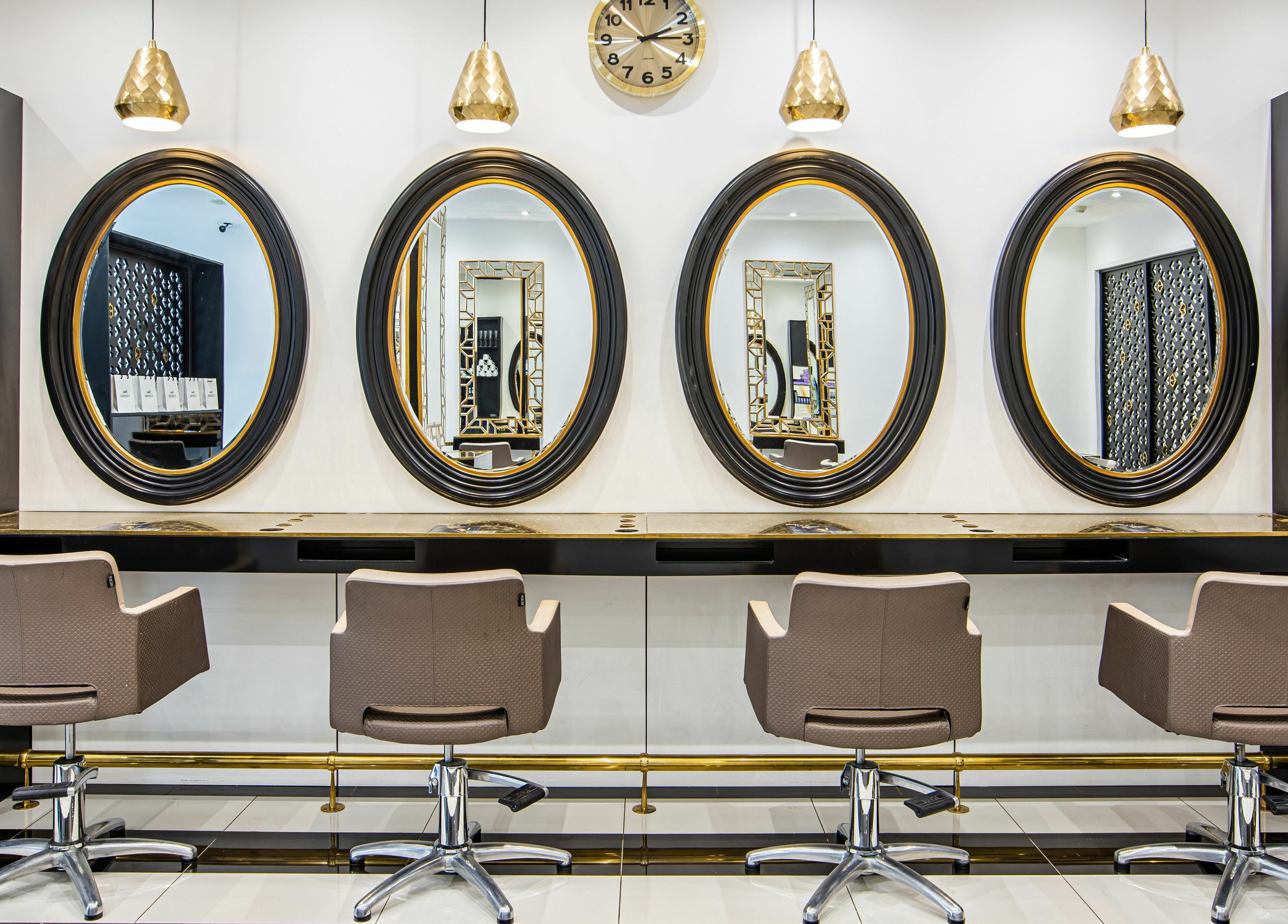 Luxurious seating and mirrors at The Ivy Salon, Torquay, England, GB, showcasing stylish decor.