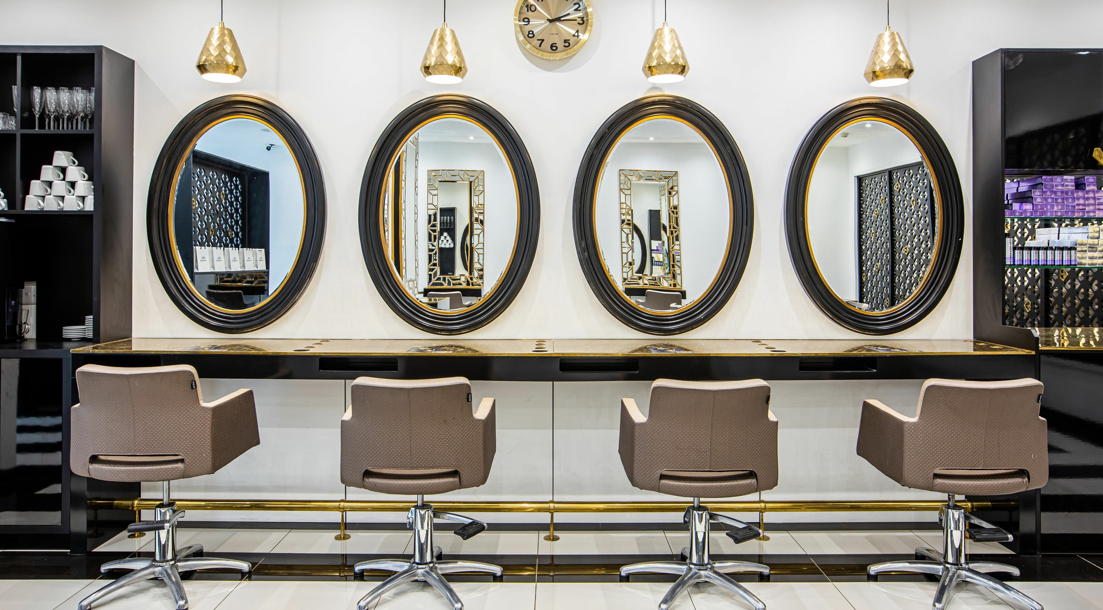 Luxurious seating and mirrors at The Ivy Salon, Torquay, England, GB, showcasing stylish decor.