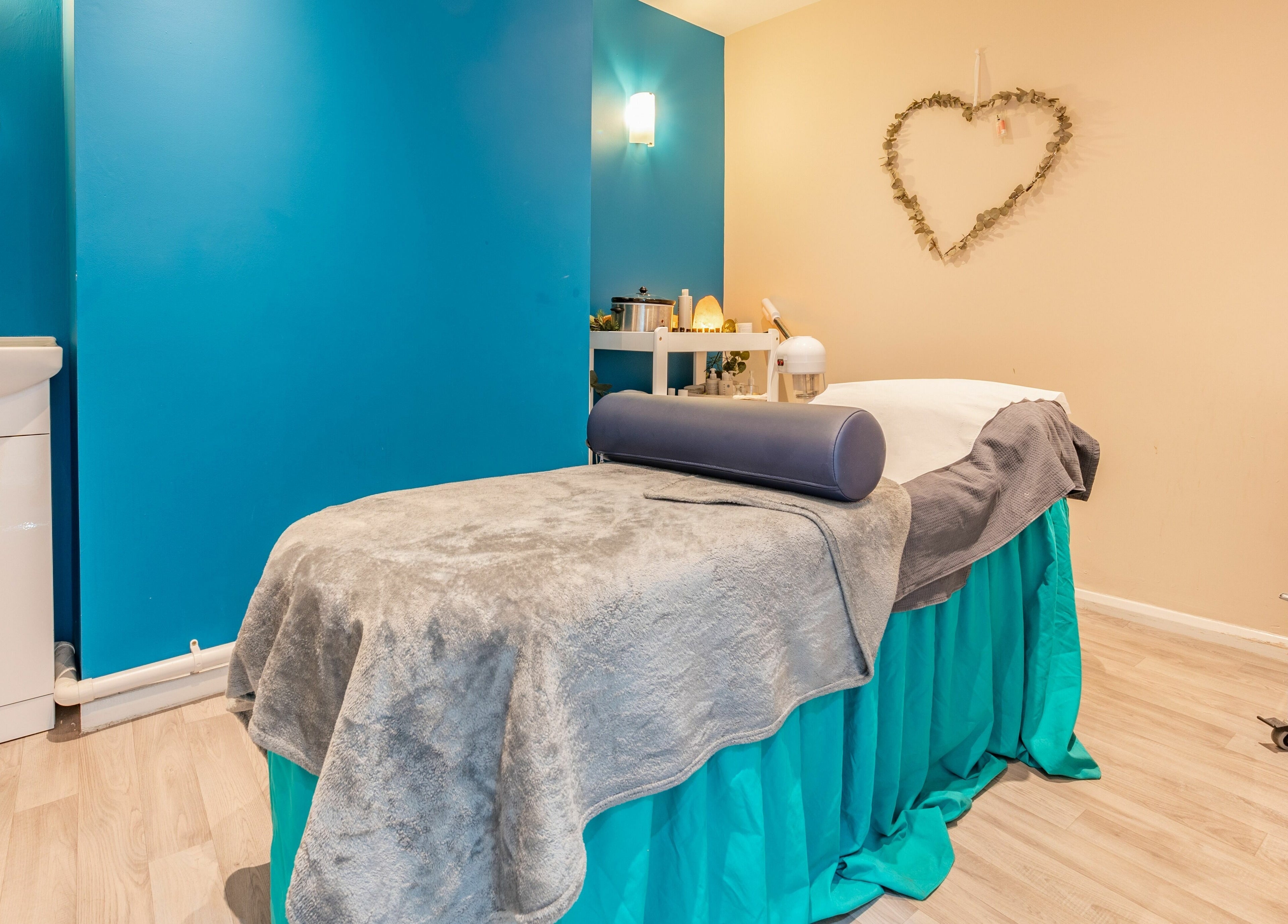 Relaxing massage room at Radiate Health and Beauty, Stockport, England, GB with serene blue and beige decor.