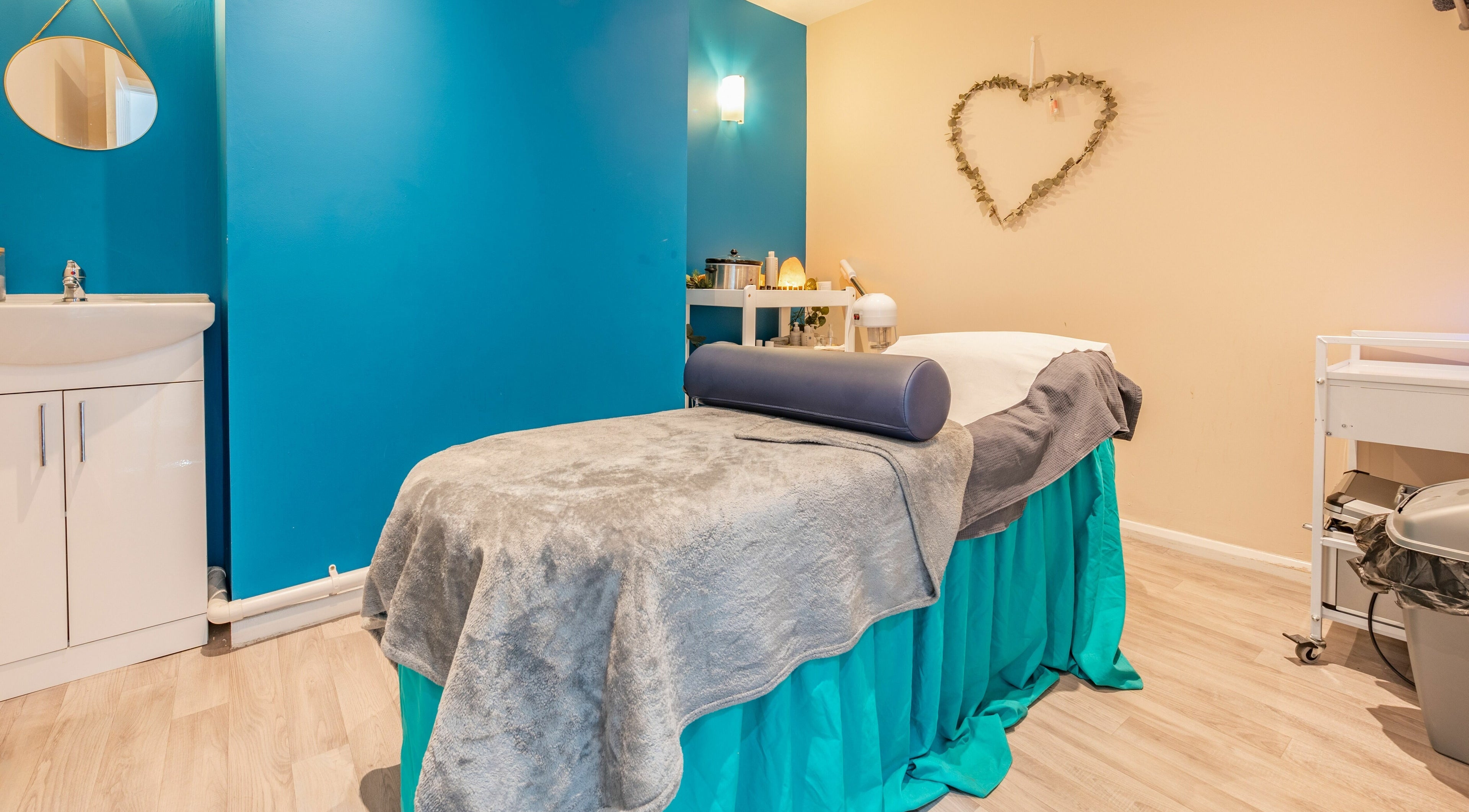 Relaxing massage room at Radiate Health and Beauty, Stockport, England, GB with serene blue and beige decor.
