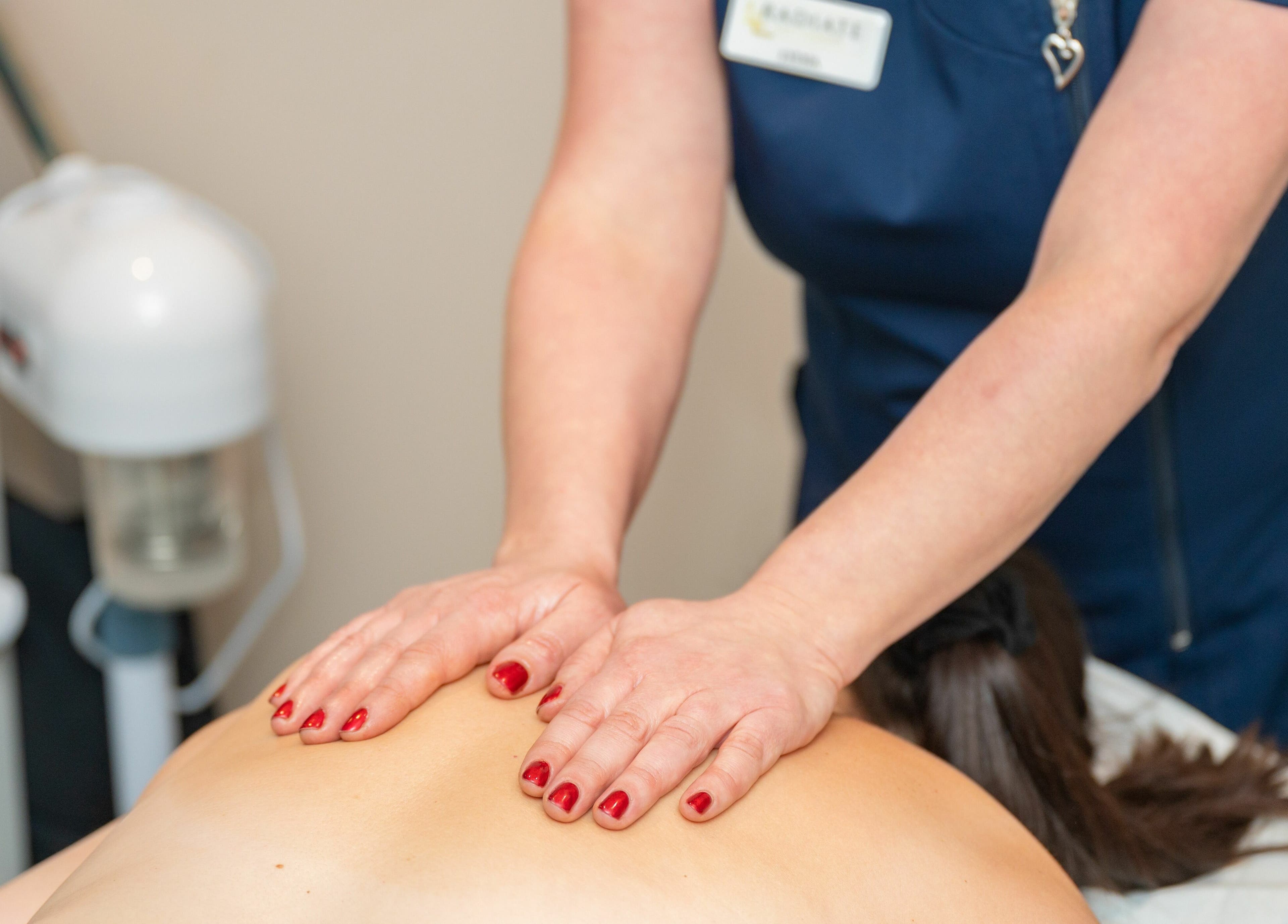 Massage therapist at Radiate Health and Beauty, Stockport, England, GB providing a relaxing back massage.