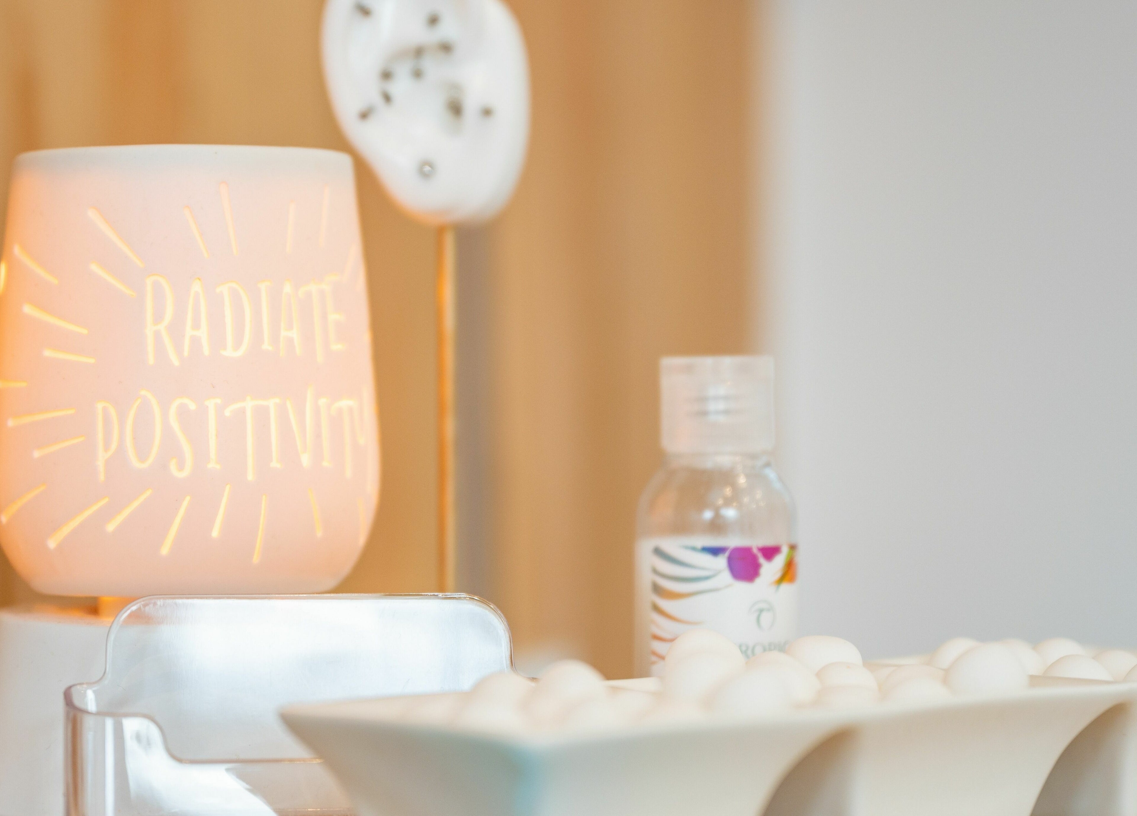 Radiate Health and Beauty candle in Stockport, England, GB with positivity message and spa decor.