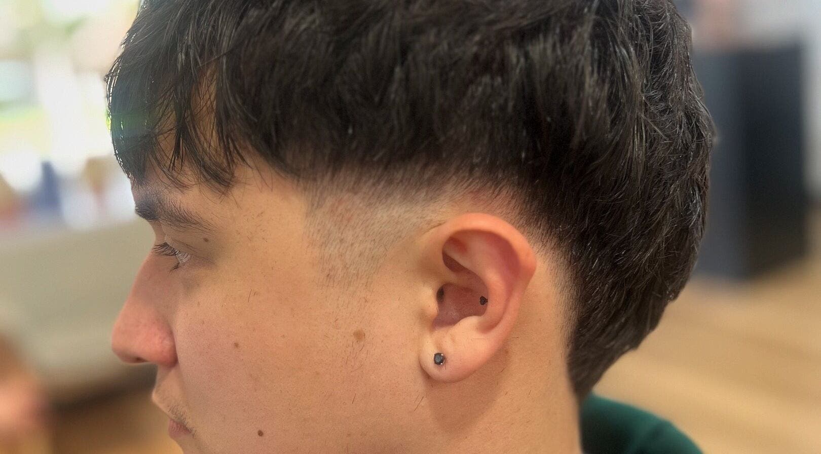 Tapered haircut at Hair Artistry Studio, Camden, New South Wales, AU, showcasing sleek style.