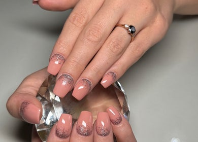 Elegant manicured nails with glitter design at Myrakia Beauty & Laser Bar, Benoni, Gauteng, ZA.