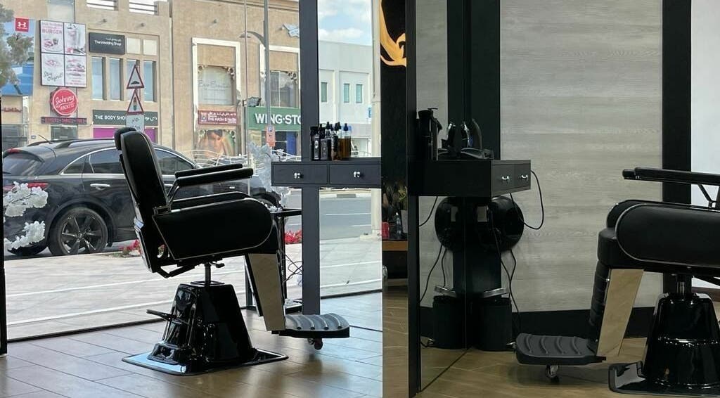 Modern barber chair at Brothers Salon and Spa, Dubai, AE, overlooking a busy street through a large window.