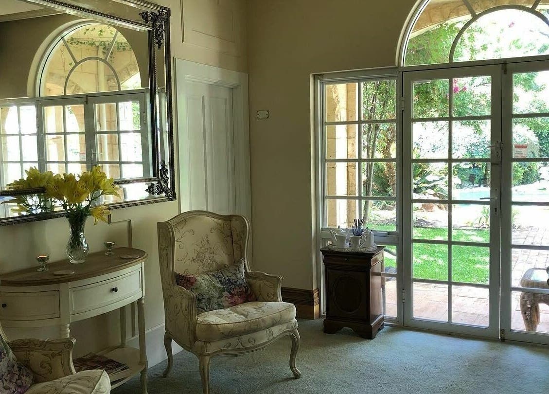 Elegant seating area in Brookleigh Beauty and Spa, Upper Swan, Western Australia, AU with garden view.