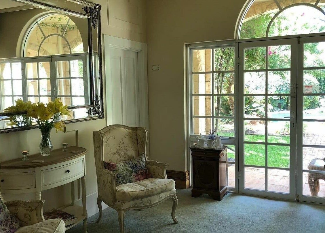 Elegant seating area in Brookleigh Beauty and Spa, Upper Swan, Western Australia, AU with garden view.