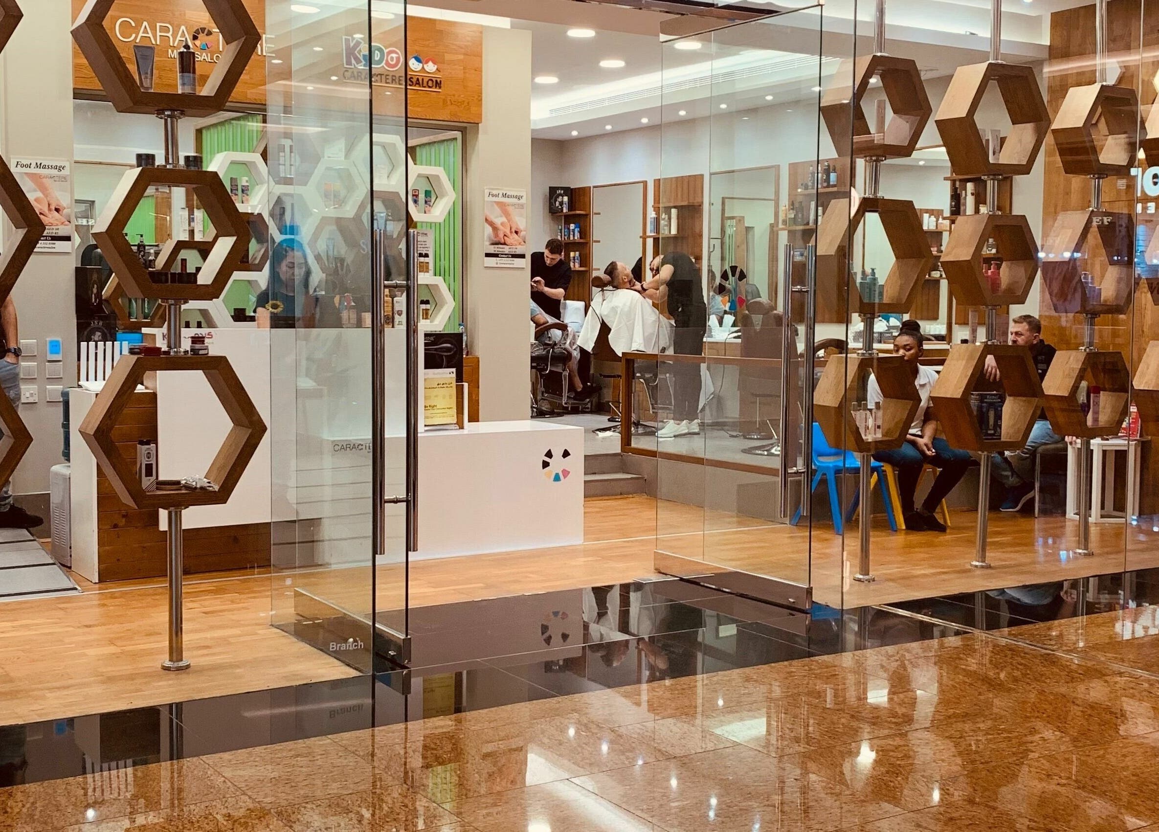 Entrance of Caractere Salon Mall of the Emirates, Dubai, AE with stylish hexagon shelves.