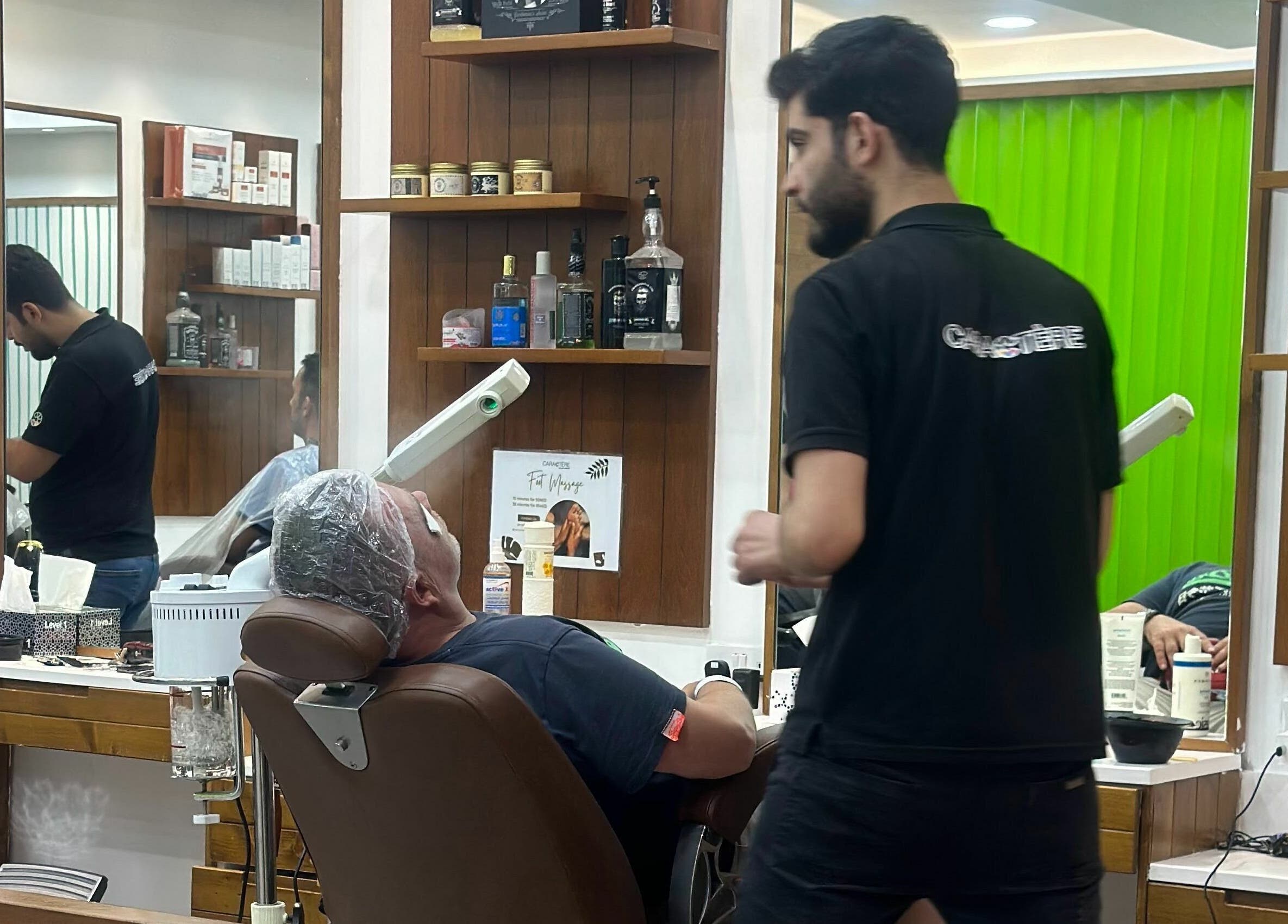 Man receiving a facial treatment at Caractere Salon Mall of the Emirates, Dubai, AE.