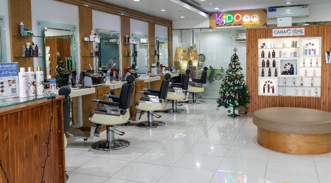Chic interior of Caractere Salon -كاريكتير - Motor City in Dubai, AE with stylist chairs and product display.