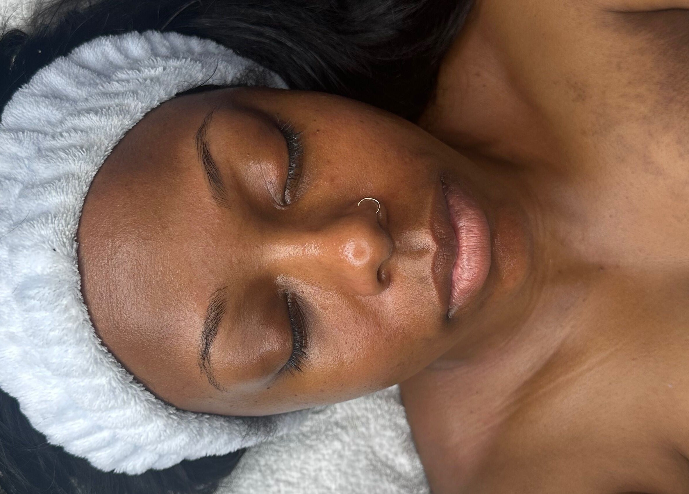 Relaxed woman with headband enjoying facial at Created by Lonna Skin and Body Spa, Belleville, New Jersey, US.