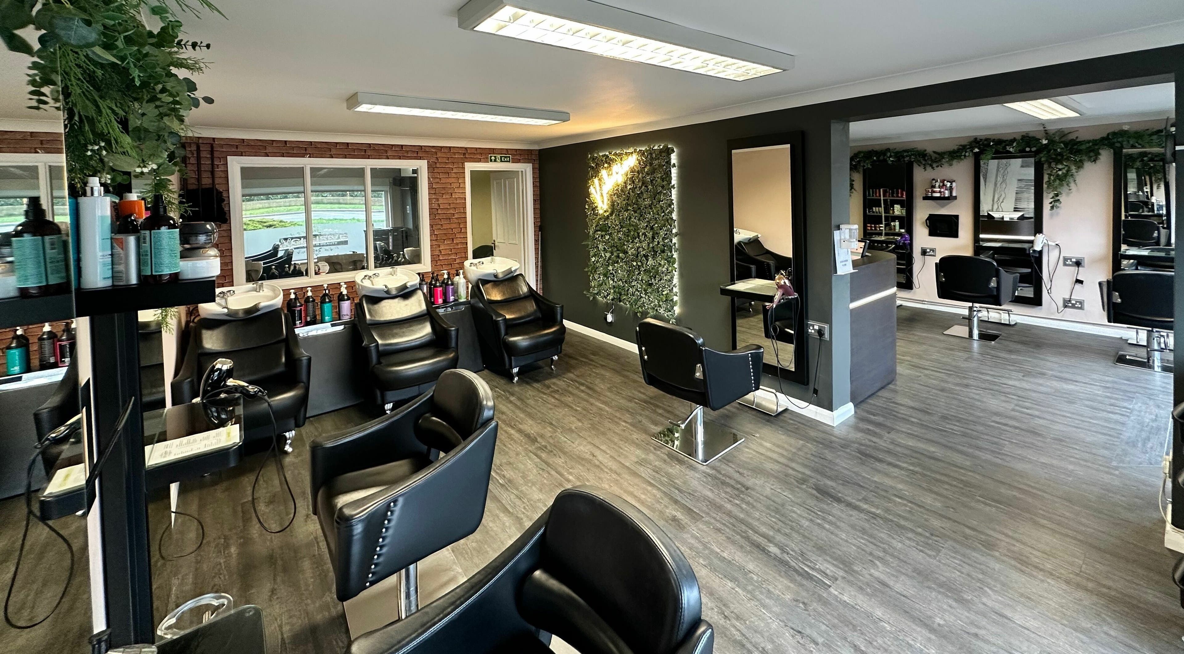 Modern salon interior at Xclusive Hair, Bournemouth, England, GB, showcasing stylish chairs and mirrors.