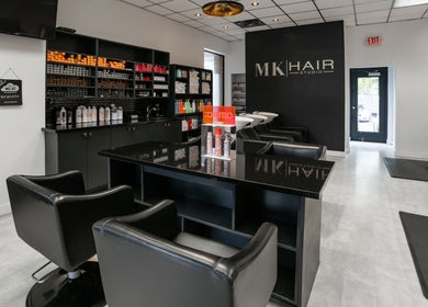 Interior of Mk Hair Studio, Mississauga, Ontario, CA, featuring sleek styling stations and product displays.