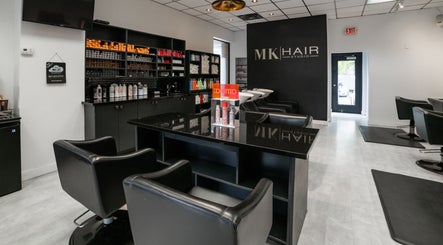 Interior of Mk Hair Studio, Mississauga, Ontario, CA, featuring sleek styling stations and product displays.