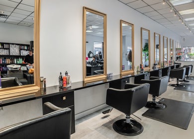 Interior of Mk Hair Studio in Mississauga, Ontario, CA, featuring stylish salon chairs and mirrors.