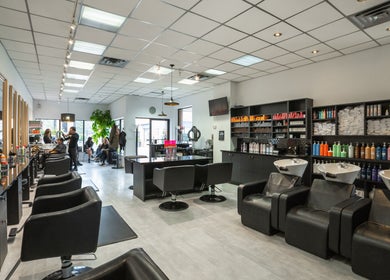 Interior of Mk Hair Studio in Mississauga, Ontario, CA, showcasing modern salon chairs and sleek decor.
