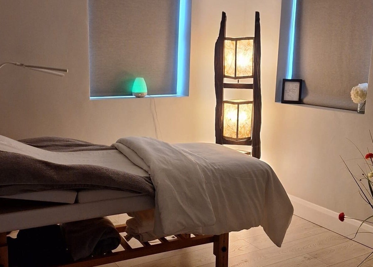 Relaxing massage room at Be Yourself in County Wexford, IE, with soft lighting and a cozy table.