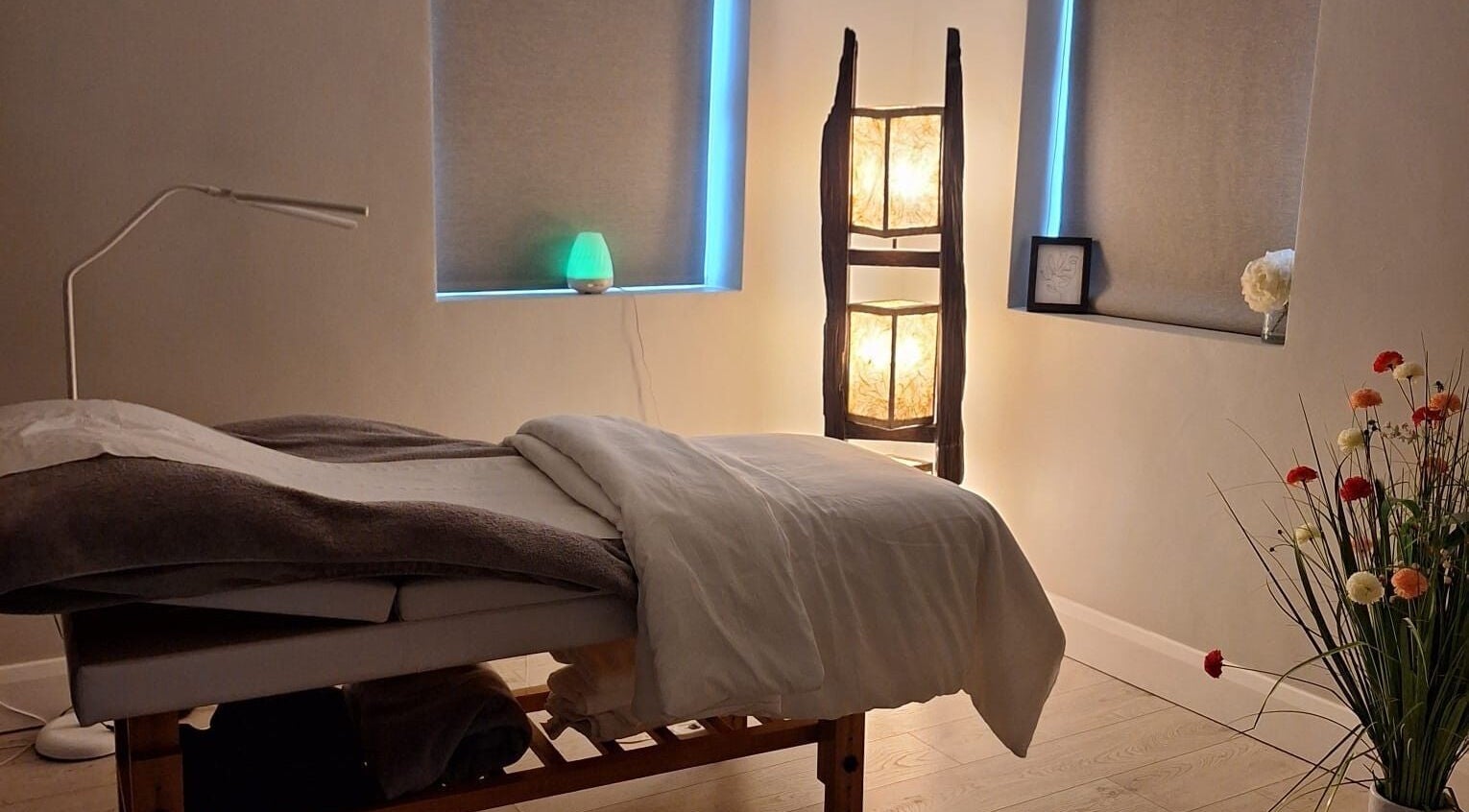 Relaxing massage room at Be Yourself in County Wexford, IE, with soft lighting and a cozy table.