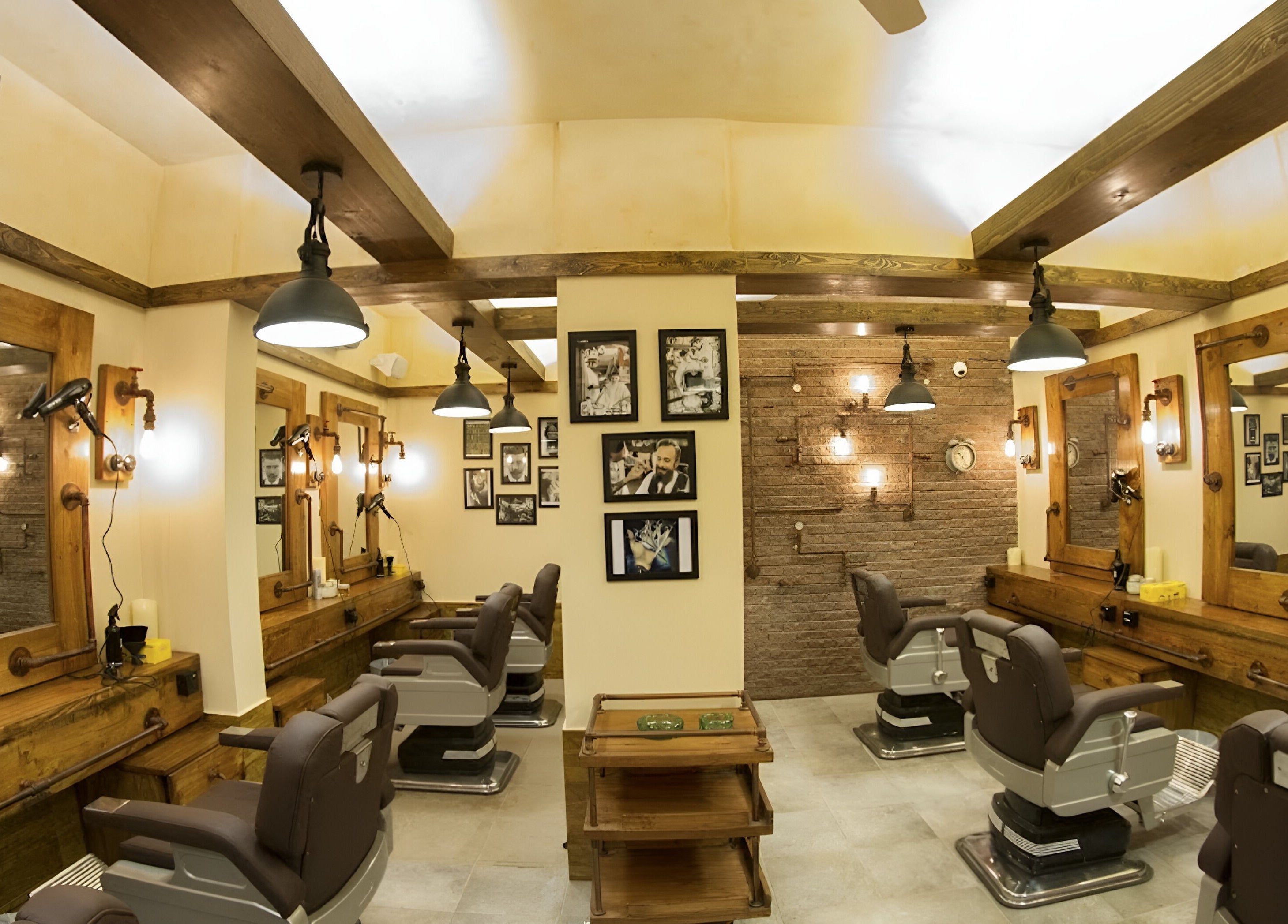 Modern rustic interior of Clippers Salon Zamzama Branch, Karachi, Sindh, PK with stylish seating and framed art.