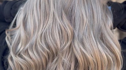 Luxurious silver-blonde waves styled at Cai The Stylist, Benoni, Gauteng, ZA, showcasing expert color blending.