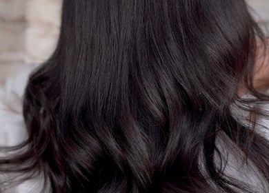 Elegant wavy, dark hair styled at Cai The Stylist, located in Benoni, Gauteng, ZA.