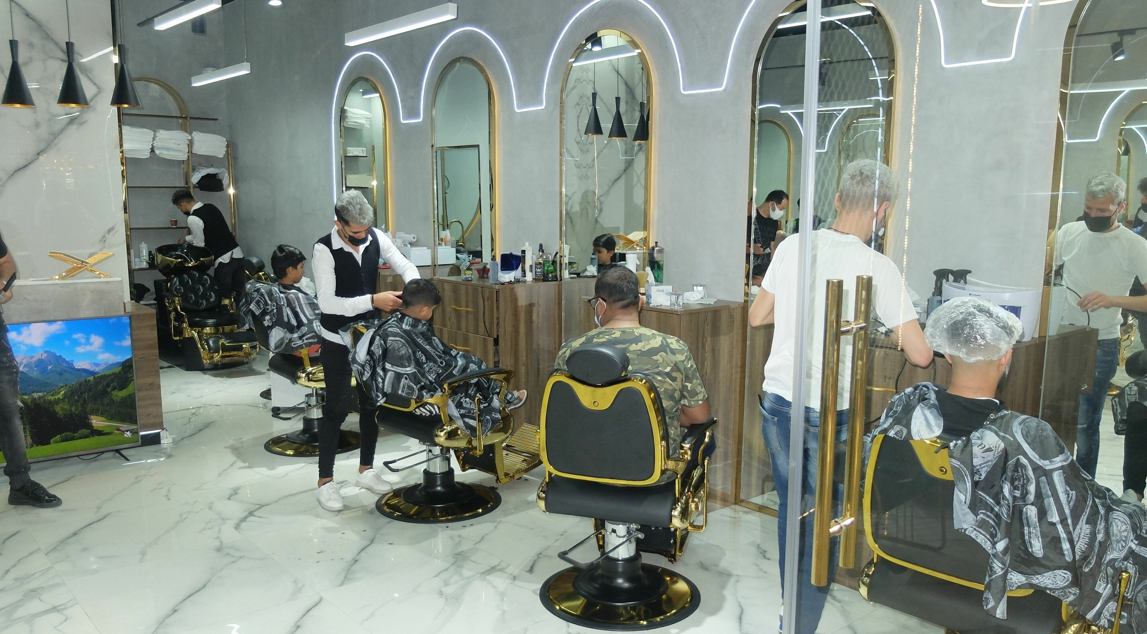 Stylish interior of Tito Brothers Gents Salon in Dubai, AE, showcasing professional barbers at work.