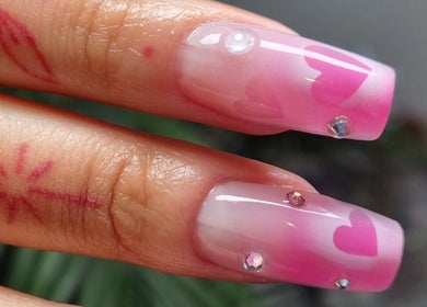 Elegant heart-themed nail art with gems at Purple On My Fingers in London, England, GB.