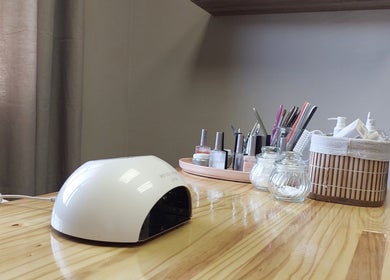 Nail essentials at Nails by Anja in Windhoek, Khomas Region, NA with tools and polish on a wooden table.