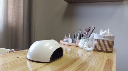 Nail essentials at Nails by Anja in Windhoek, Khomas Region, NA with tools and polish on a wooden table.