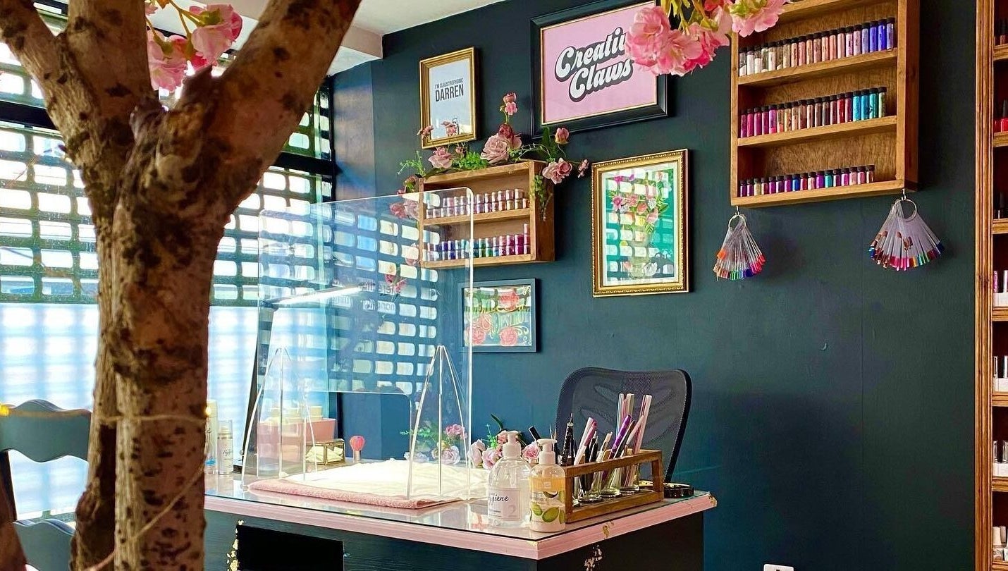 Interior of Creative Claws Salon and Training Academy in Holyhead, Wales, GB, showcasing a stylish nail station.