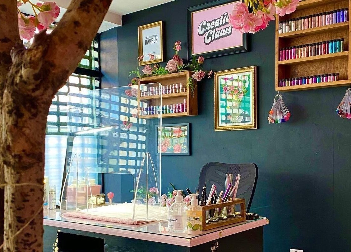 Interior of Creative Claws Salon and Training Academy in Holyhead, Wales, GB, showcasing a stylish nail station.