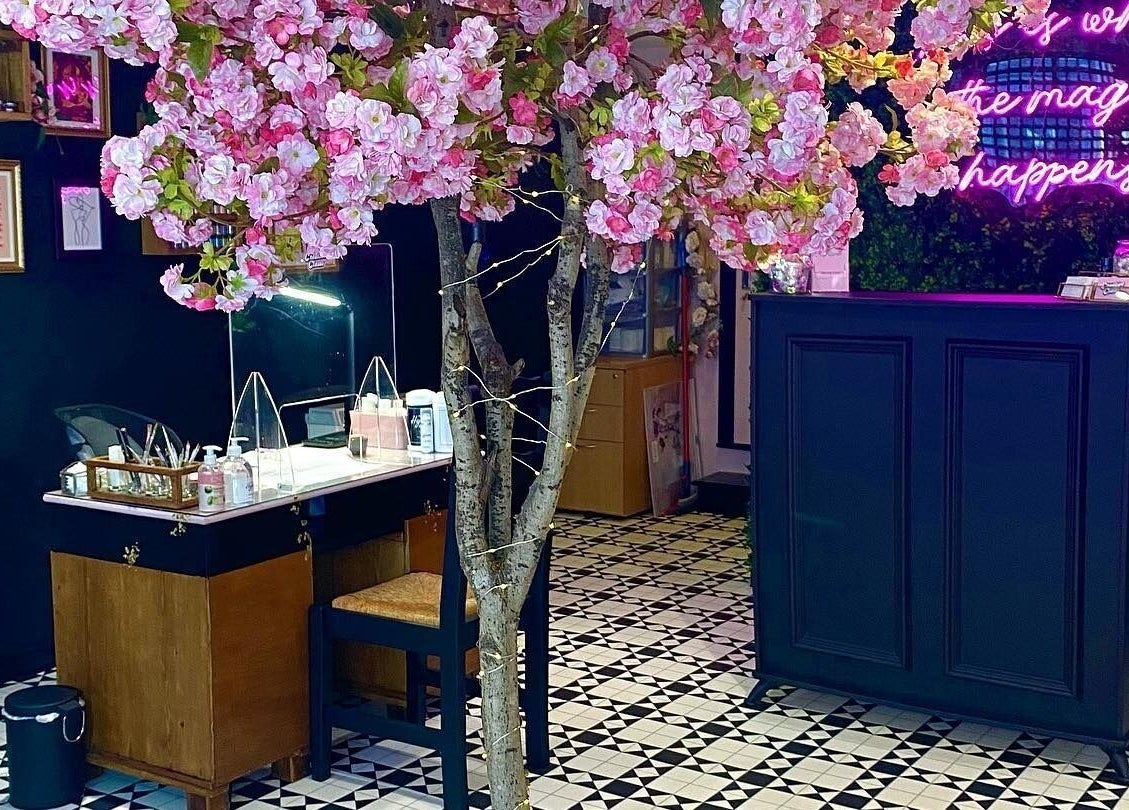Creative Claws Salon and Training Academy in Holyhead, Wales, GB, with cherry blossoms and elegant decor.