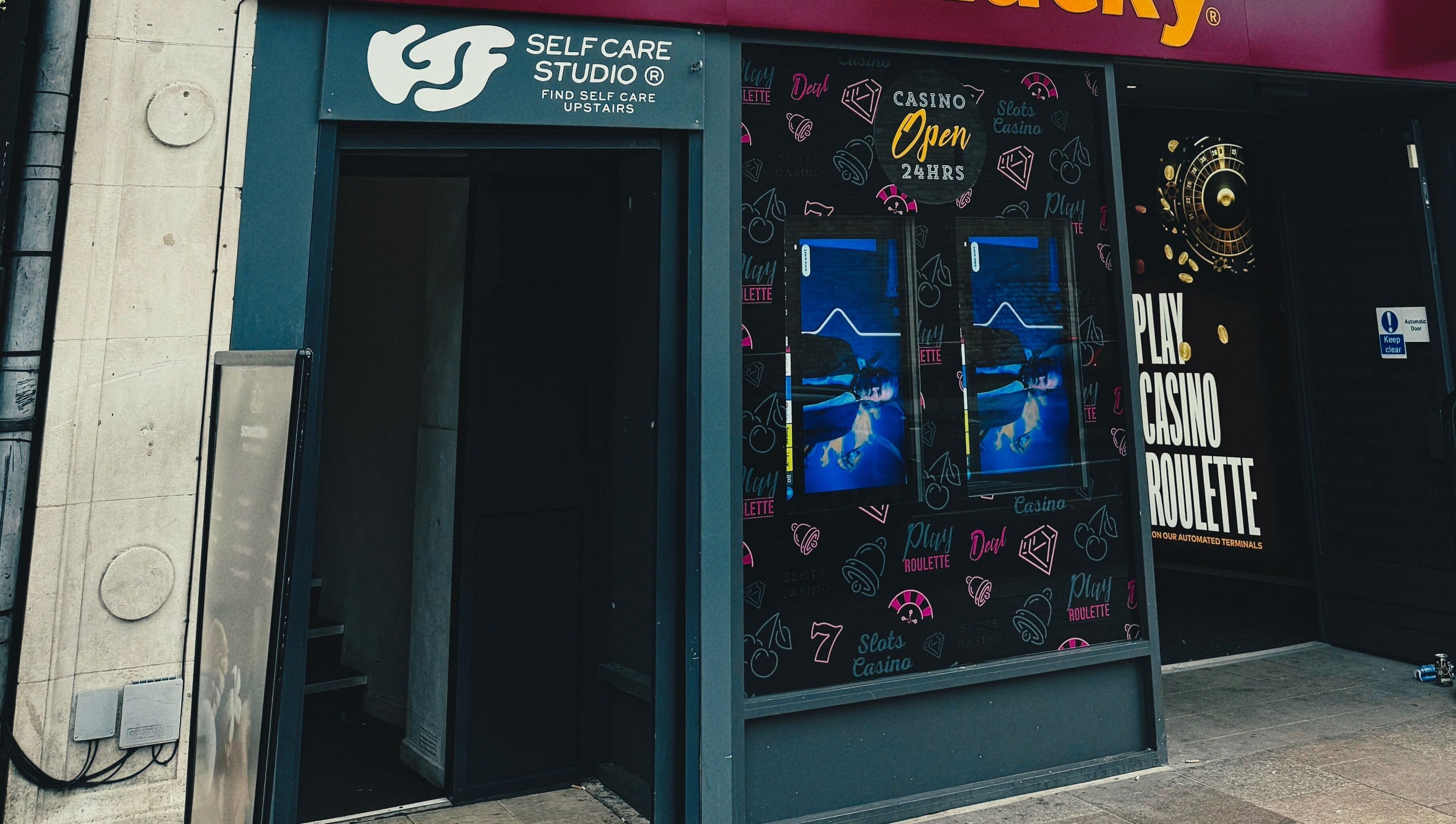 Entrance to KTF Self Care Studio in Cardiff, Wales, GB, showcasing unique signage and inviting atmosphere.
