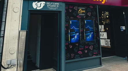 Entrance to KTF Self Care Studio in Cardiff, Wales, GB, showcasing unique signage and inviting atmosphere.