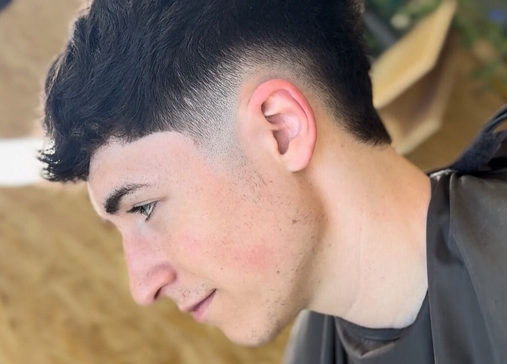Modern haircut at KTF Self Care Studio in Cardiff, Wales, GB showcasing a stylish fade cut.