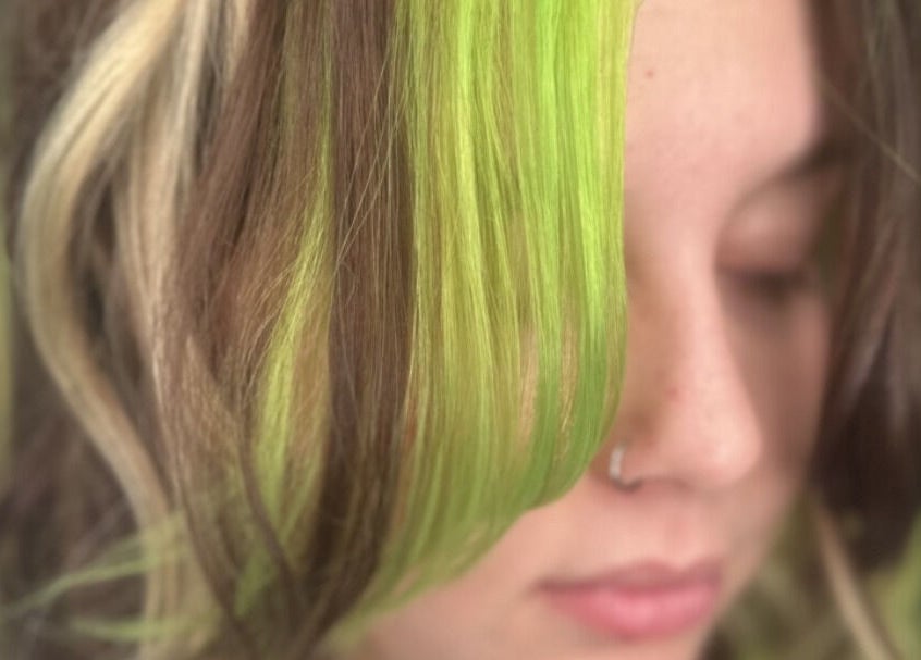 Close-up of unique green-highlighted hair at KTF Self Care Studio, Cardiff, Wales, GB.