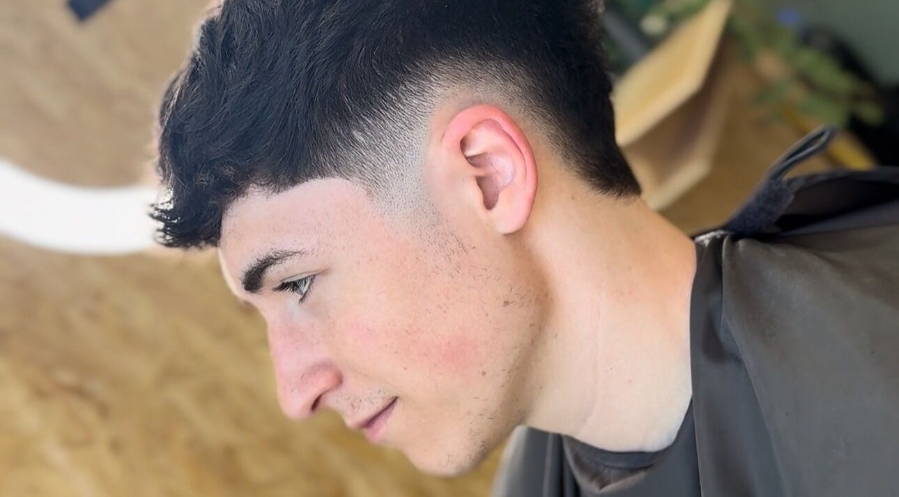 Close-up of a sleek haircut at KTF Self Care Studio, Cardiff, Wales, GB showcasing a professional fade style.