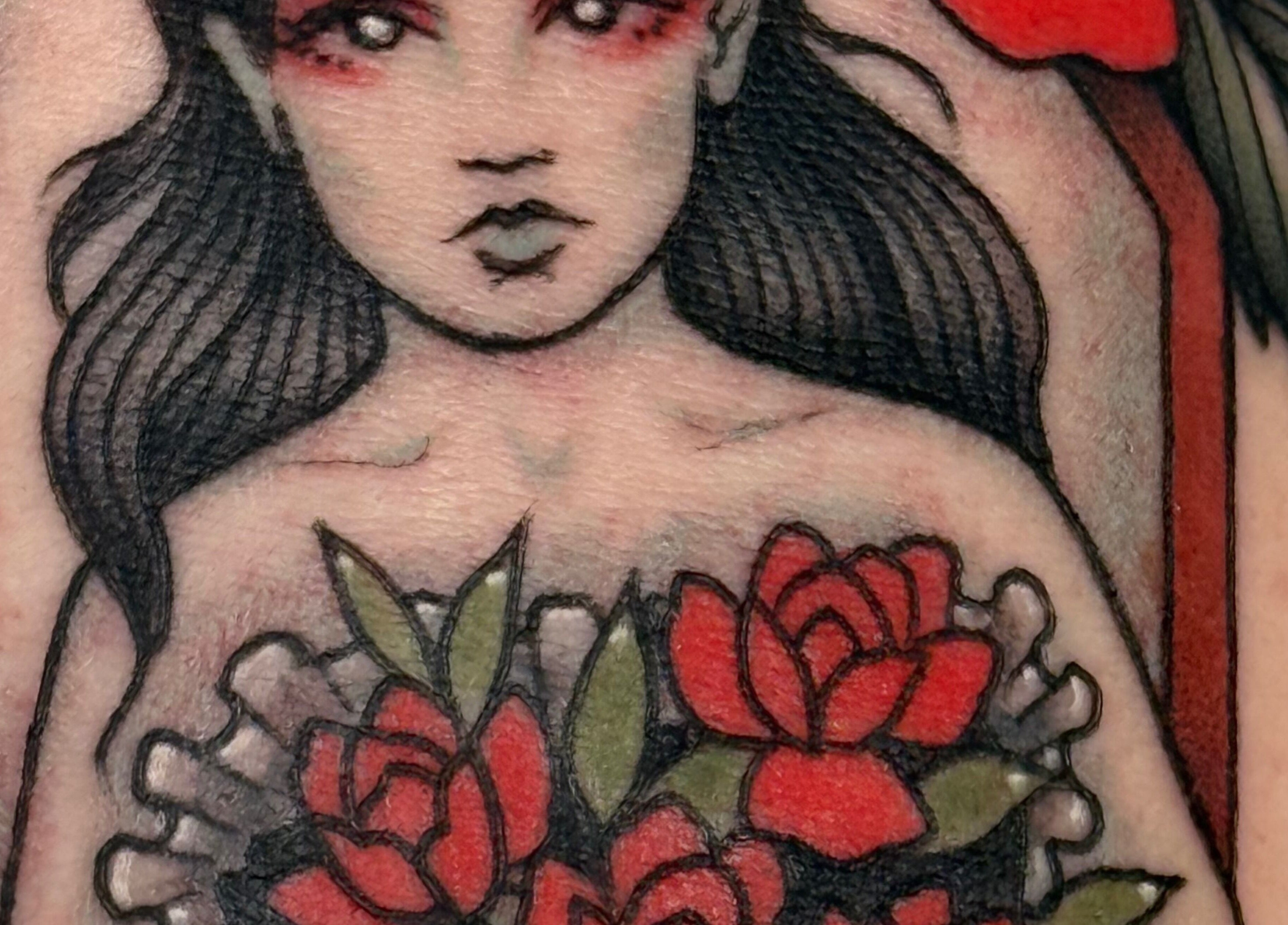 A vivid tattoo of a woman with roses at KTF Self Care Studio, Cardiff, Wales, GB.