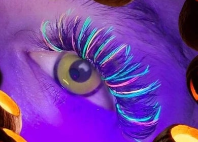 Vibrant neon lashes at Lashed with Cee, Torquay, England, GB amid Halloween decor.