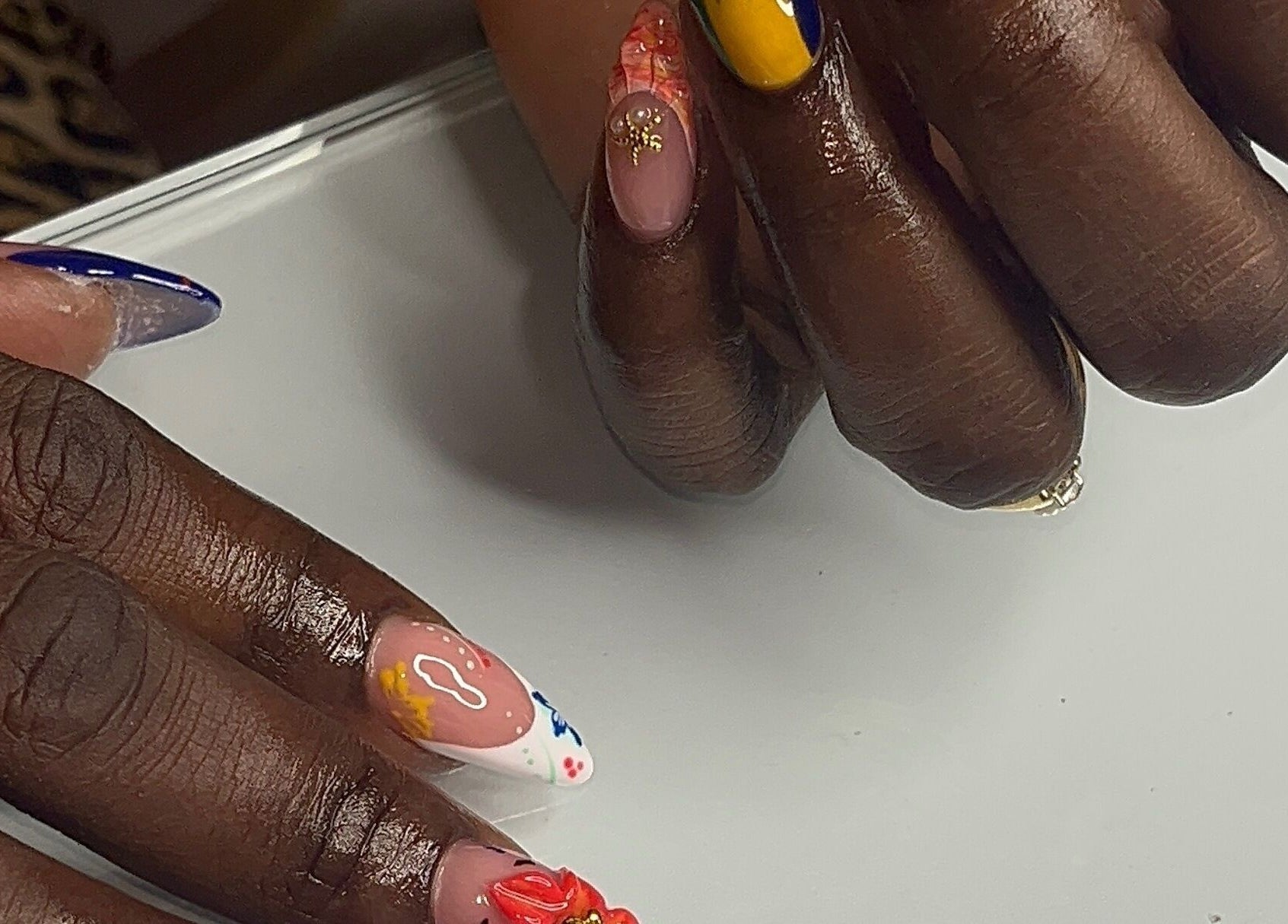 Colorful nail art at Nail Essentialsss in Bridgetown, Saint Michael, BB showcasing creative designs.