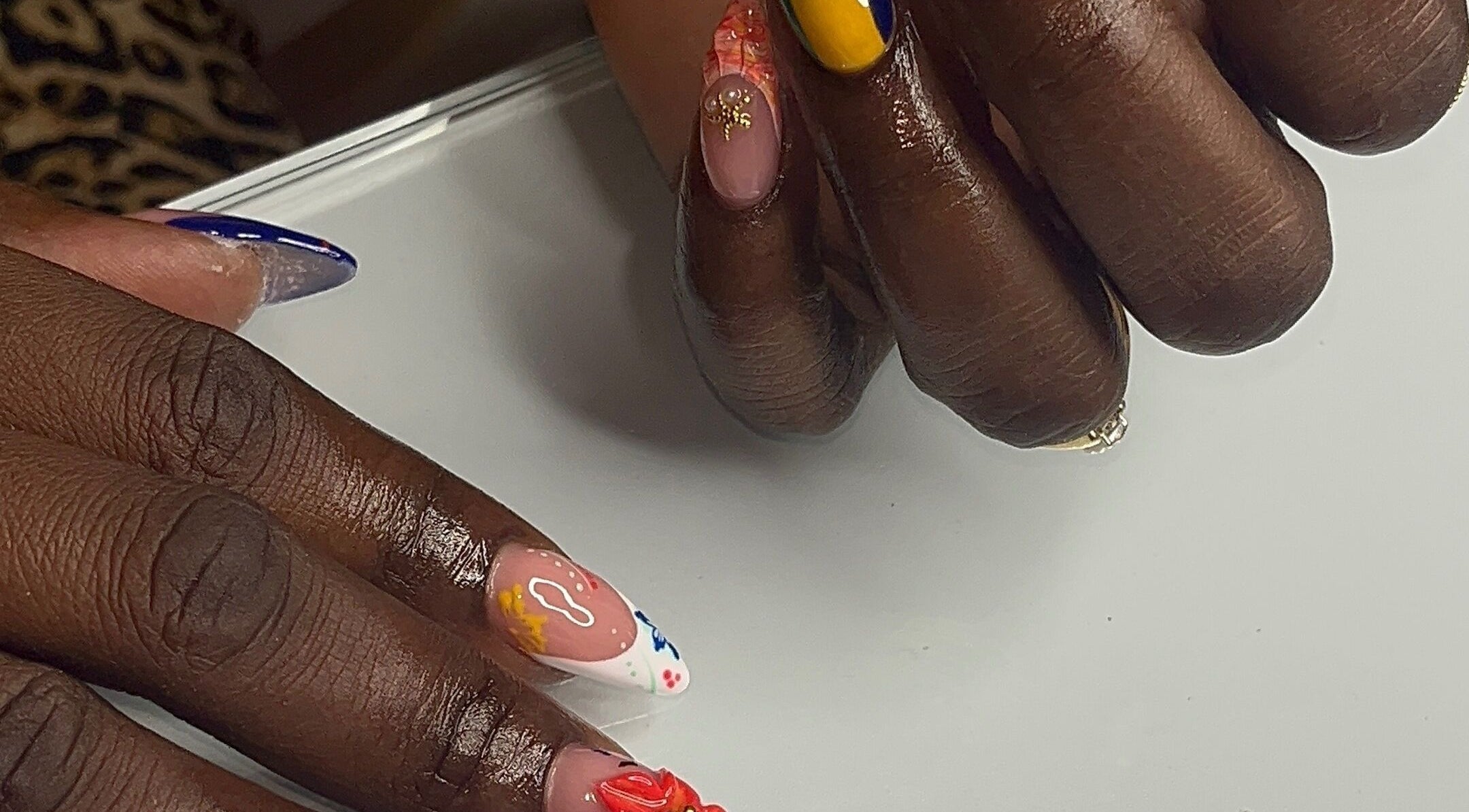 Colorful nail art at Nail Essentialsss in Bridgetown, Saint Michael, BB showcasing creative designs.