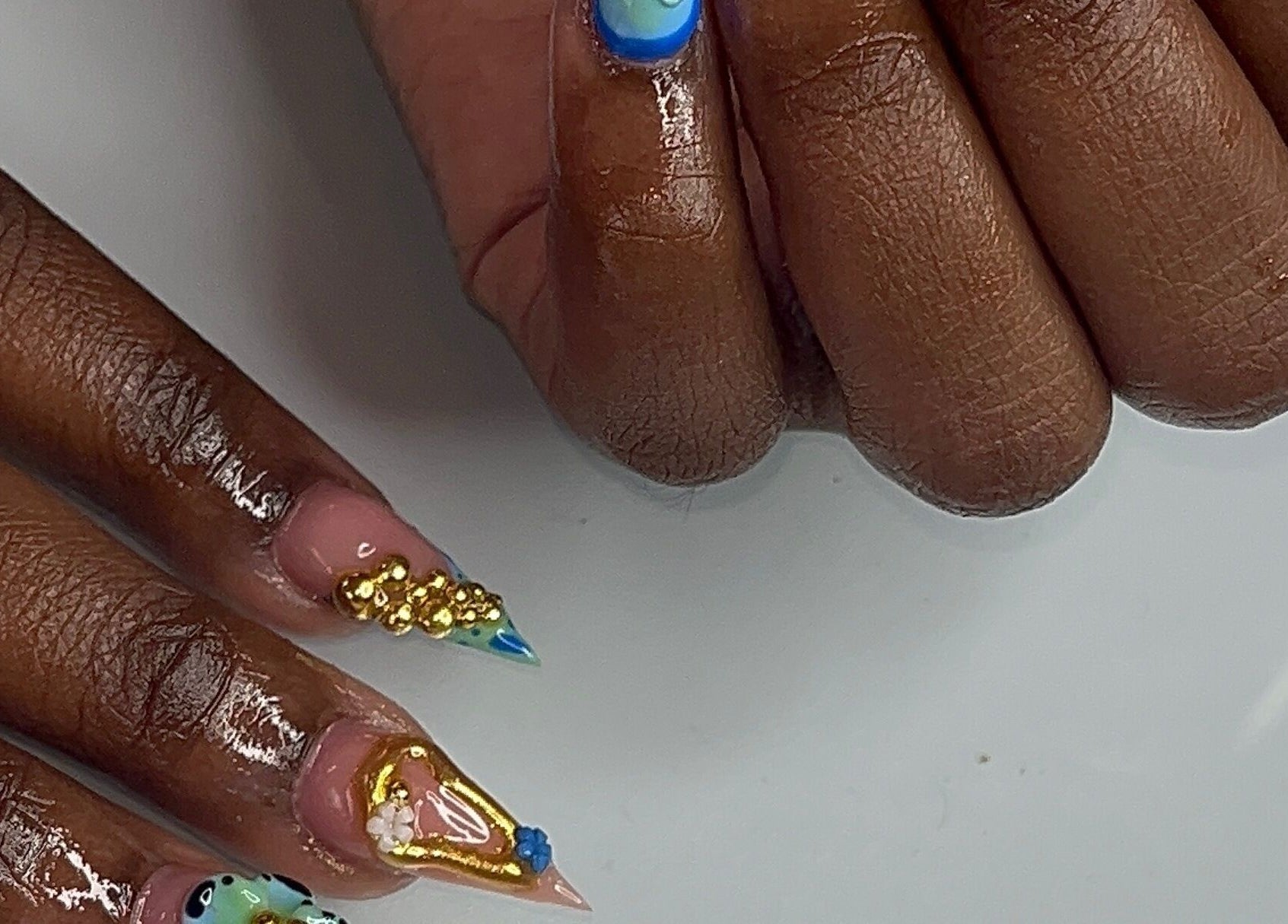 Intricate nail art by Nail Essentialsss in Bridgetown, Saint Michael, BB highlighting vibrant designs and colors.