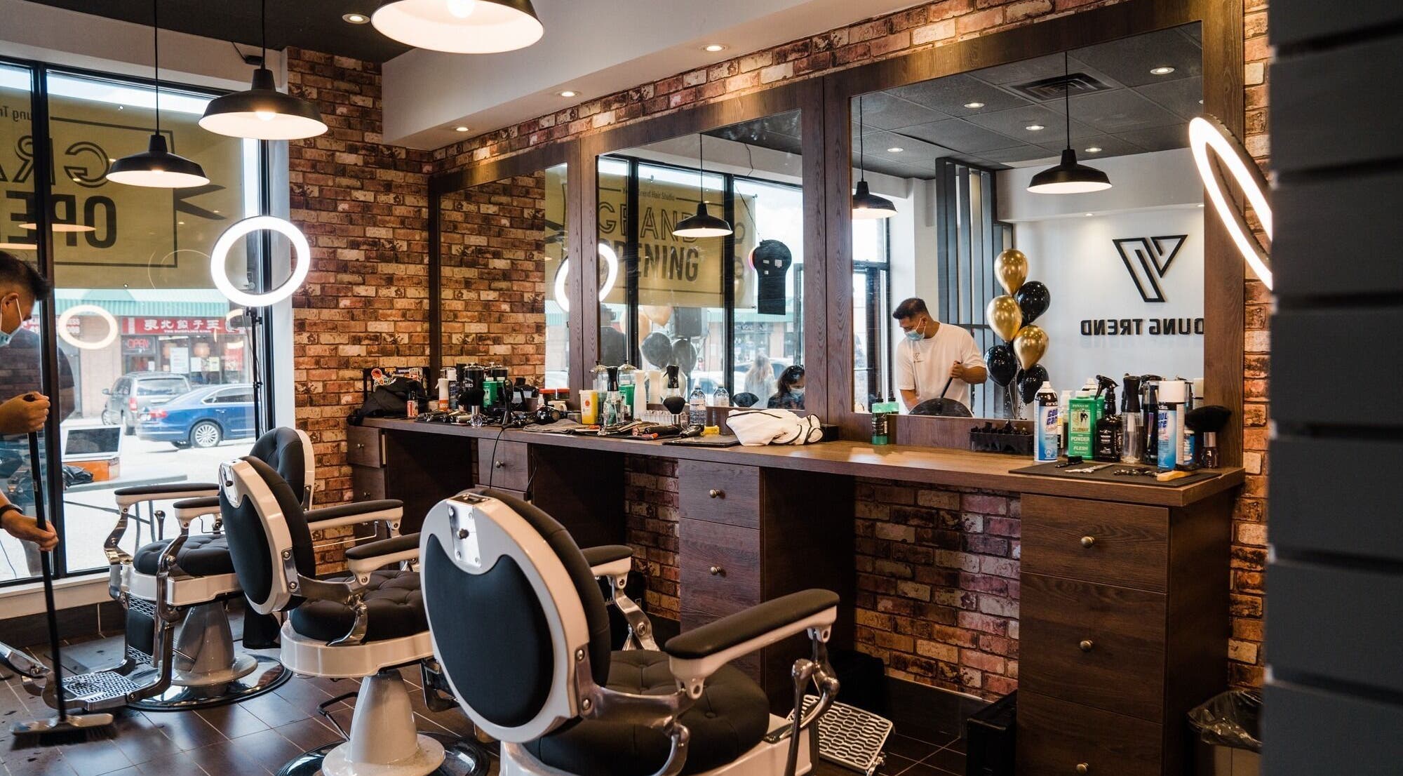 Inside Young Trend Hair Studio Midland Finch in Toronto, Ontario, CA, featuring stylish barber chairs and mirrors.