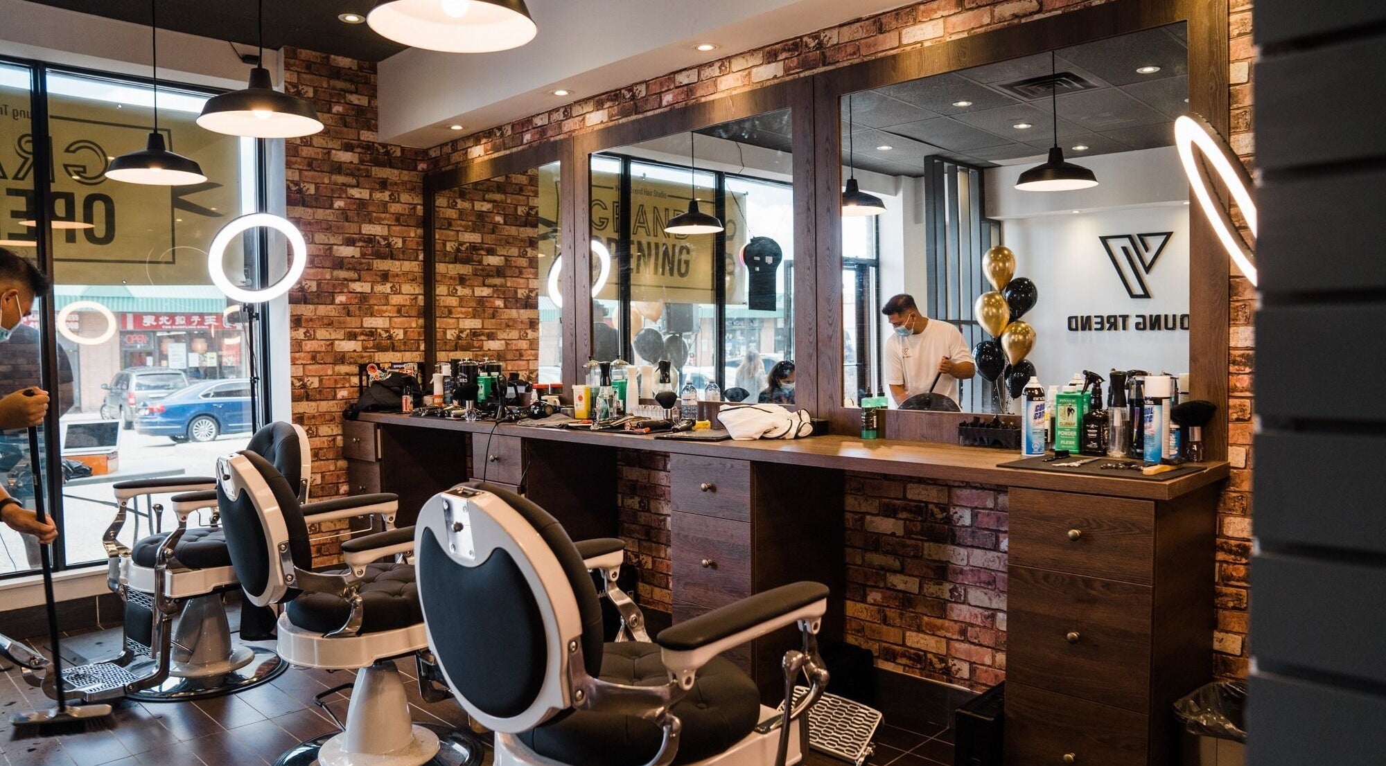 Inside Young Trend Hair Studio Midland Finch in Toronto, Ontario, CA, featuring stylish barber chairs and mirrors.