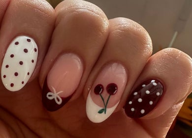 Stylish cherry-themed nail art at St Neots Nail Fairy, St Neots, England, GB.