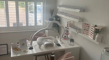 Modern nail station setup at St Neots Nail Fairy, St Neots, England, GB, showcasing a vibrant polish collection.