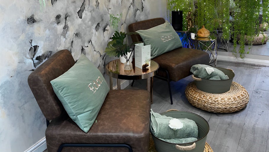 Cozy seating area at Eden Salon, Tyldesley, England, with plush cushions and calming decor.