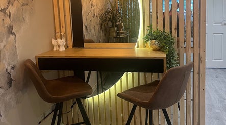Chic seating and mirror at Eden Salon, Tyldesley, England, GB. Perfect for beauty and relaxation.