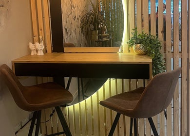 Elegant seating at Eden Salon, Tyldesley, England, GB, showcasing a stylish, well-lit beauty station.